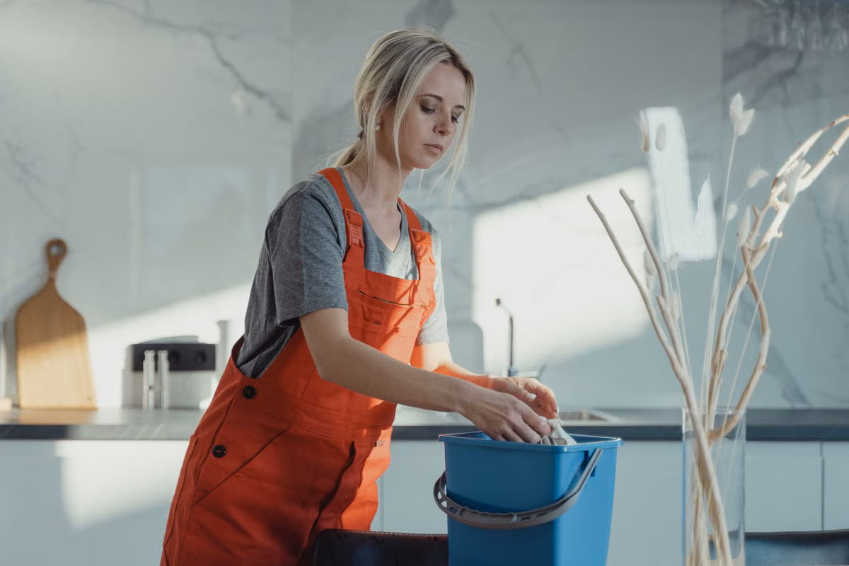 Kimberlys Janitorial Service cleaner wiping a bright Tulsa home kitchen